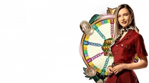 Image featuring a female host standing next to a spinning game wheel, promoting the Snakes and Ladders live game at Gizbo.